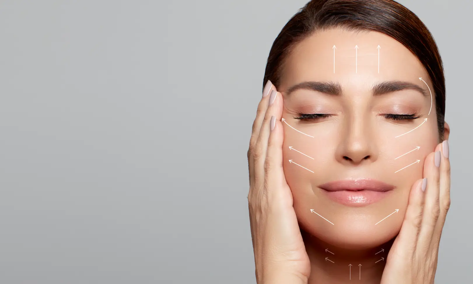 Woman holds both sides of her face with white arrows pointing upward across her forehead, cheeks, and jawline.